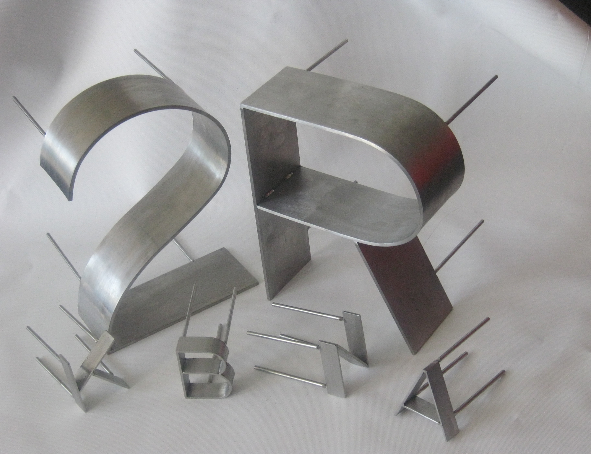 Rolled and fabricated flat bar letters